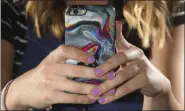  ?? RICK BOWMER — ASSOCIATED PRESS ?? Rachel Whalen looks at her phone at her home in Draper, Utah, on July 22.