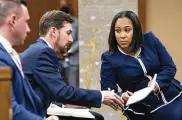  ?? AP ?? Fulton County District Attorney Fani Willis talks with her team during proceeding­s to seat a special purpose grand jury to look into whether former President Donald Trump illegally tried to influence the 2020 election in Georgia.