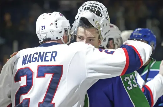  ?? MICHAEL BELL/REGINA LEADER-POST ?? Regina Pats forward Austin Wagner, hugs Swift Current Broncos goalie Jordan Papirny at the end of the seventh game of the Eastern Conference semi-final series at the Brandt Centre. The Pats won 5-1.