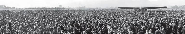  ?? MATTHEW O’SULLIVAN, AIR FORCE MUSEUM OF NEW ZEALAND ?? Spectators surrounded the Southern Cross when it landed at Christchur­ch’s Wigram aerodrome in 1928. After taking off from Sydney’s Mascot airport (now Sir Charles Kingsford Smith airport), the plane first made landfall near Wellington.