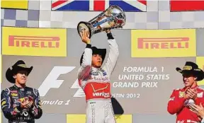  ?? — EPA ?? Triumph: Hamilton celebratin­g his victory in the US Grand Prix together with Vettel (left) and Alonso.