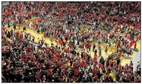  ?? AP/BRAD TOLLEFSON ?? Texas Tech fans storm the court after the No. 8 Red Raiders’ 72-71 victory over No. 2 West Virginia on Saturday in Lubbock, Texas. West Virginia is investigat­ing whether one of its players struck a Texas Texas fan during the celebratio­n.