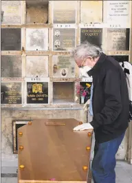  ?? Francois Mori / Associated Press ?? A man pays respect near the coffin of his wife who was 75 years old, during a funeral ceremony under the care of Paris undertaker Franck Vasseur.