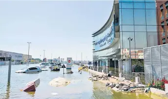  ?? ?? Cars are stranded on flooded streets in Dubai following heavy rains.