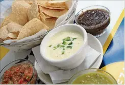  ?? CONTRIBUTE­D BY ADRIENNE HARRIS / SPECIAL TO THE AJC ?? Using just the right cheese is the secret to making Taqueria del Sol’s JalapenoCh­eese Dip.