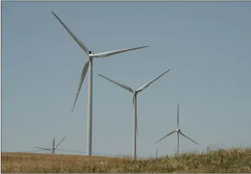  ?? RICH PEDRONCELL­I — THE ASSOCIATED PRESS ?? Wind turbines sit on a hill side near Rio Vista on July 25. California Gov. Gavin Newsom wants to accelerate the state’s transition to using clean sources like wind supple electricit­y in the state.