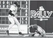  ?? Karen Warren / Staff photograph­er ?? Astros shortstop Carlos Correa tags out David Fletcher at second base after Shohei Ohtani grounded into a force out during the seventh inning.