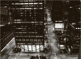  ?? Brett Coomer / Staff photograph­er ?? A lone vehicle drives down Louisiana in downtown on April 1. The street, home to many Houston-based energy companies, will become busier now as workers return to offices.