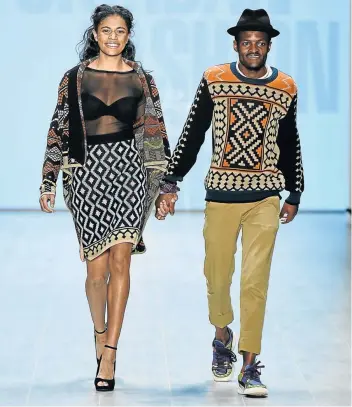  ?? Picture: GETTY IMAGES/FRAZER HARRISON ?? MADE IT: Designer Laduma Ngxokolo, right, and a model on the runway at the 1981 Maxhosa By Laduma Soboye show in Berlin, Germany in 2014.