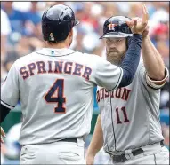  ?? AP/CHRIS YOUNG ?? Houston catcher Evan Gattis (right) is congratula­ted by right fielder George Springer after Gattis’ three-run home run in the sixth inning of Sunday’s 19-1 blowout of Toronto.