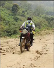  ?? ?? Bawa rides on a motorbike along a road.