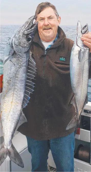  ?? Picture: BOB McPHERSON ?? DOUBLE HEADER: Lachie Wombell with a couple of the gemfish he caught offshore from Portland recently.
