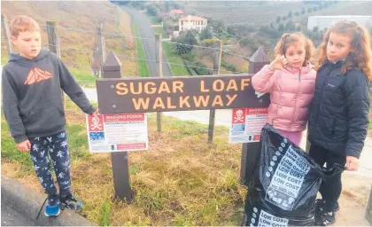  ??  ?? It takes Wellington­ians on holiday to pick up rubbish in our ‘backyard’. Isabel 10, William 8 and Grace 6, Musson from Ngaio while holidaying in Taradale, went up Sugar Loaf and collected bags of bottles, cans and plastic before breakfast last week. To cap it off a man walking up Sugar Loaf was so impressed he asked for their address and later presented a card with $5 each. Well worth the early morning walk. Photo sent in by Dr Rob Kyle.