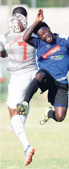  ?? RICARDO MAKYN ?? Ryan Miller of UWI FC goes up for a header with Cavalier player Paul ‘Keke’ Wilson (right) during their Red Stripe Premier League clash at the UWI Mona Bowl on March 11.