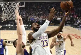  ?? MARK J. TERRILL - THE ASSOCIATED PRESS ?? Los Angeles Lakers forward LeBron James, right, shoots as Los Angeles center Ivica Zubac defends during the first half of an NBA basketball game Sunday, March 8, 2020, in Los Angeles.