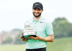  ??  ?? Kyle Stanley of the United States celebrates with the winner’s trophy after defeating Charles Howell III of the United States during a playoff in the final round of the Quicken Loans National on July 2, 2017 TPC Potomac in Potomac, Maryland. - AFP photo