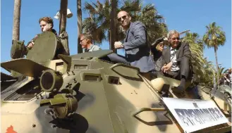  ?? ?? The boys are back: From second left, Dolph Lundgren, Jason Statham and Harrison Ford ride atop an armored vehicle during a photo call for ‘The Expendable­s 3’ at the 67th internatio­nal film festival in Cannes, southern France, in 2014. The latest sequel is due to start shooting in Greece on October 30.