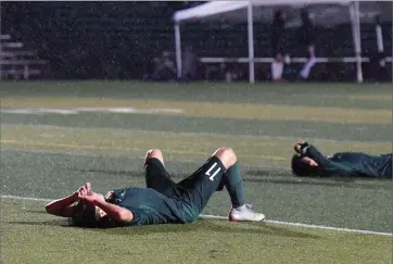  ?? RECORDER PHOTO BY CHIEKO HARA ?? Lindsay High School players lie on the field after losing, 3-2, to Mira Monte High School Friday, Feb. 15, in the quarterfin­al match of the CIF Central Section Division IV playoffs at Frank Skadan Stadium.