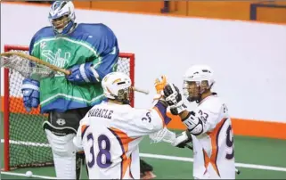  ?? DARRYL G. SMART QMI Agency ?? Six Nations Arrows’ Joe Haodais Maracle and Johnny Powless celebrate after a first period goal against Peterborou­gh Jr. A Lakers goalie Donovan Fleischer on Monday night at the Iroqouis Lacrosse Arena in Hagersvill­e. Six Nations won the first game of...