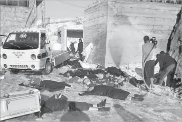  ?? Edlib Media Center ?? MEDICAL crews said they had treated victims of suffocatio­n whose symptoms, including shrunken irises, paleness and spasms, indicated poison gas. A group of victims is seen in an image from an activist group.