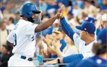  ?? Robert Gauthier Los Angeles Times ?? MANAGER Dave Roberts is the first to welcome Andrew Toles back to the dugout after he scored Dodgers’ first run in the third.