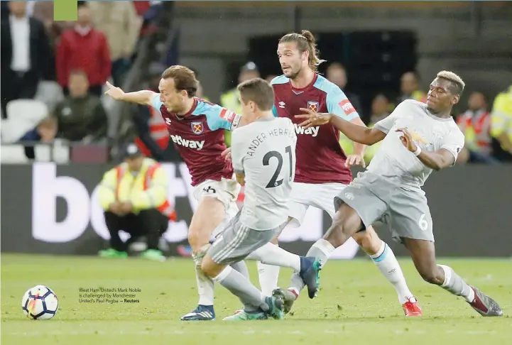  ?? — Reuters ?? West Ham United’s Mark Noble is challenged by Manchester United’s Paul Pogba.