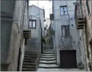  ?? CAIN BURDEAU VIA AP ?? This photo shows a view of steep steps of a passageway in Geraci Siculo, a mountainto­p medieval town in the Madonie Mountains in northern Sicily. The Madonie are a world apart from Sicily’s packed summertime beaches and busy coastlines. This wild region of Sicily is known for its towns atop hills and mountains, its delicious food, ornate churches and friendly people.