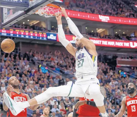  ?? KIM RAFF/AP ?? The Jazz’s Rudy Gobert, dunking against the Rockets on Feb. 22, said his relationsh­ip with teammate Donovan Mitchell will never be perfect after both players endured the coronaviru­s.