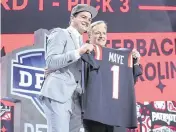  ?? KIRBY LEE USA TODAY Sports ?? Former UNC quarterbac­k Drake Maye poses with NFL commission­er Roger Goodell after being selected by the New England Patriots as the No. 3 pick in the first round of the 2024 NFL Draft on Thursday night in Detroit.