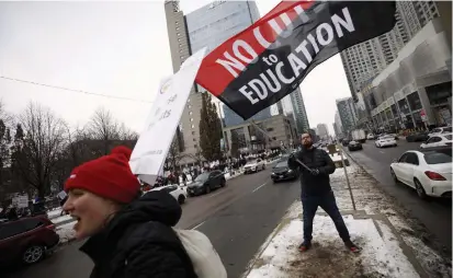  ?? COLE BURSTON THE CANADIAN PRESS FILE PHOTO ?? Teachers from the Ontario Secondary School Teachers’ Federation picket in December. The OSSTF is the last union without a deal.