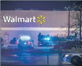  ?? ?? Police deployed outside a Walmart store in the American state of Virginia, where a store employee opened fire late on Tuesday, killing six people, officials said, in the second highprofil­e mass killing in a handful of days. The assailant is also dead. The shooting came days after a person opened fire at a gay nightclub in Colorado killing five people.