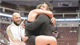  ?? GARRETT/SPECIAL TO THE MORNING CALL DAVID ?? Inside
Bethlehem Catholic’s Tyler Kasak jumps into coach Jeff Karam’s arms after winning the PIAA Class 3A 126-pound title last month at Hershey’s Giant Center.