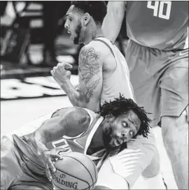  ?? Robert Gauthier Los Angeles Times ?? PATRICK BEVERLEY pushes past the Suns’ Cameron Payne during the first half of Game 4 of the Western Conference finals. The Suns won 84-80.