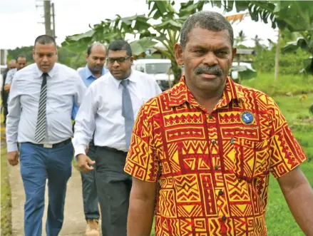  ??  ?? The Minister for Lands and Mineral Resources Ashneel Sudhakar (left) and Minister for Agricultur­e, Rural and Maritime Developmen­t, Waterways and Environmen­t Mahendra Reddy (third from left) are escorted to Waicoka Village in Rewa.