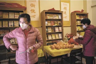  ??  ?? Amanda Ho, a volunteer with Guan Yin Citta Culture Center, continues to do her community work, mindful of the rising fear of antiAsian hate crimes in San Francisco’s Chinatown.