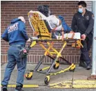  ?? JOHN MINCHILLO/AP ?? Emergency medical service workers on Sunday in New York.