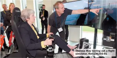  ?? ?? Theresa May testing out a flight simulator. Ref:136255-91