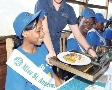  ??  ?? Farm Queen contestant Miss St Ann was excited to receive her main course from General Manager Zoe Alexander.