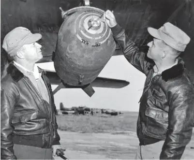  ??  ?? Maj. Gen. Howard S. McGee (left) and Maj. Homer Hutchinson look over a 2,000-pound generalpur­pose bomb loaded on one of their F7F-3N Tigercats at a base in South Korea. (Photo courtesy of the Thompson Collection)