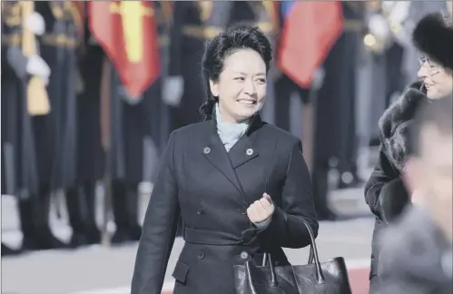  ?? Pictures: AP ?? Peng Liyuan was the focus of attention yesterday as she arrived in Moscow with husband, president Xi Jinping, below