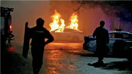  ?? ?? A burning police car during a protest against LPG cost rise following the Kazakh authoritie­s' decision to lift price caps on liquefied petroleum gas in Almaty, Kazakhstan. (Reuters)