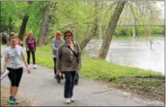  ?? MICHILEA PATTERSON — DIGITAL FIRST MEDIA ?? People take a walk along the Schuylkill River Trail in Pottstown. Both the river and the trail are great opportunit­ies for outdoor summer fun.