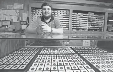  ?? PHOTOS BY PAUL VERNON/THISWEEK ?? Seth Karn, the third generation of Karns to work at Allen’s, sits behind one of the displays at the store May 27.