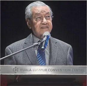 ?? — Bernama ?? Talking policies: Dr Mahathir giving his keynote address at the conference in Kuala Lumpur.