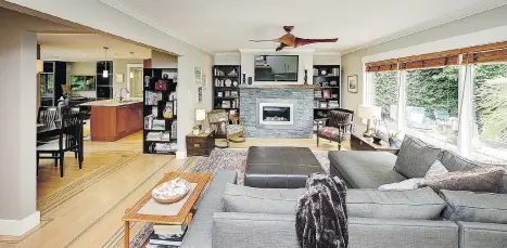  ??  ?? This home at 1098 Ferguson Rd. in Tsawwassen features a long living room framed by a wall of windows and a stone-surround floating gas fireplace.