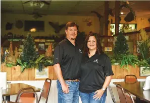  ?? Staff photo by Kelsi Brinkmeyer ?? ■ Jon and Angie McAdams, the new owners at Pier 27, stand in one of the dining areas. The couple decided to reopen the restaurant, formerly run by Jerry Sewell, as an effort to bring something they felt was needed back to their community, having many memories of the restaurant before it closed in 2015.