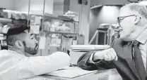  ?? Ted S. Warren / Associated Press ?? Washington Gov. Jay Inslee, right, greets a worker at the seafood counter of the Uwajimaya Asian Food and Gift Market, in Seattle’s Internatio­nal District.