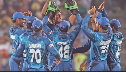  ?? — BCCI ?? Sri Lankan players celebrate the wicket of Rohit Sharma on Tuesday.