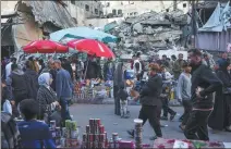  ?? FATIMA SHBAIR / ASSOCIATED PRESS ?? People buy food at a local market in Rafah, Gaza Strip, on Thursday, during the Muslim holy month of Ramadan.