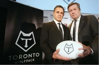  ?? VINCE TALOTTA/TORONTO STAR ?? Wolfpack coach Paul Rowley joins Toronto Mayor John Tory at the Rugby League team’s unveiling Wednesday.